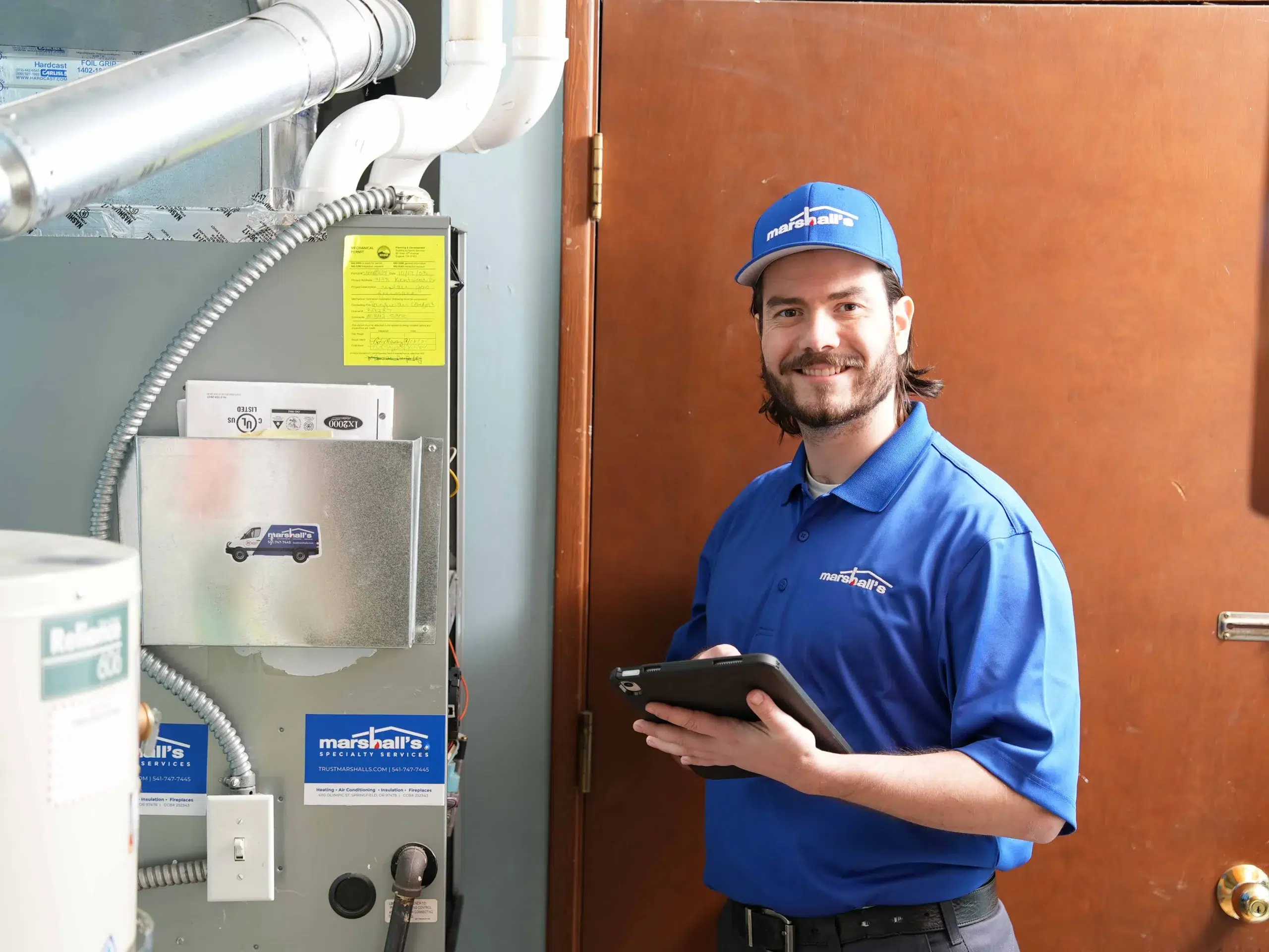 Man smiling and servicing a furnace